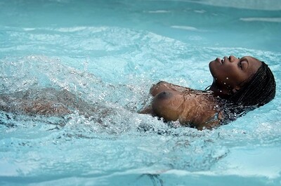 Model Deserea in Busty naked ebony babe in the pool